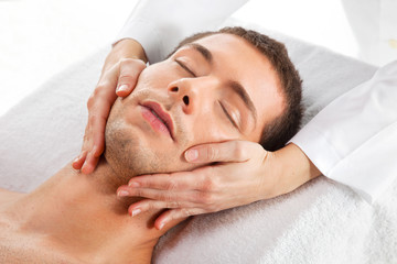 Fototapeta na wymiar Young man receiving facial massage
