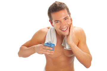 Young man applying after shave