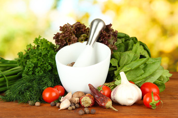 Composition of mortar, spices, tomatoes and  green herbs,