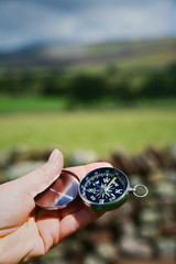 Hand Holding Compass in Rural Setting