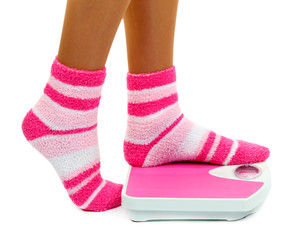 Feet on scales isolated on white