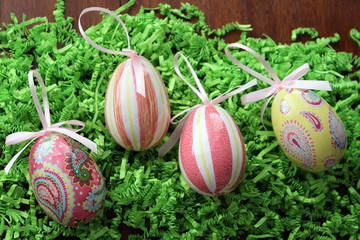 Decoupage eggs on green paper grass