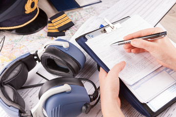 Airplane pilot filling in flight plan