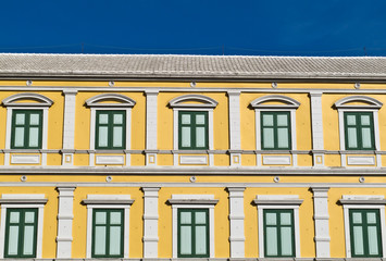 Fototapeta premium Green window on the yellow wall old Thai ancient building