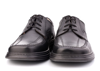 Black glossy man’s shoes with shoelaces