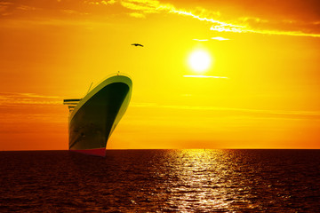 Big ship on sunrise in the sea.