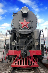 Old steam locomotive against blue sky