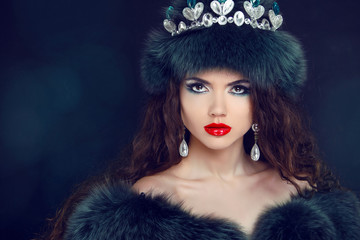 Jewelry and Beauty. Beautiful  woman model wearing in fur coat.