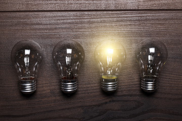 bulb uniqueness concept on wooden background