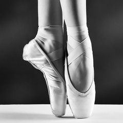 A photo of ballerina's pointes on black background