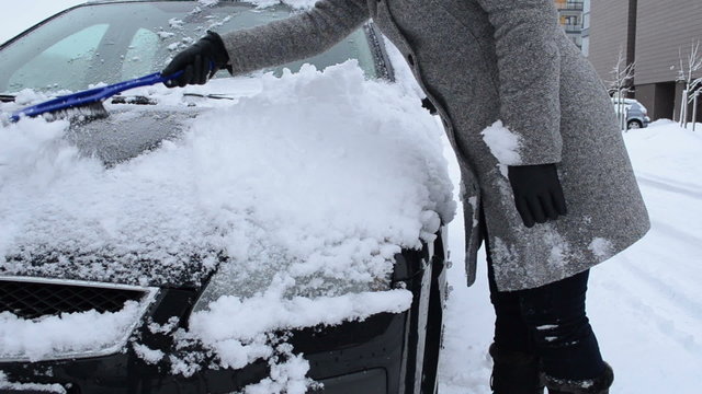 woman clean remove snow car windshield capote brush tool winter