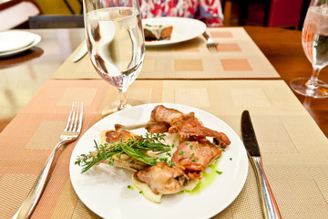 Plate with roasted rabbit and herb mashed potato in a restauran