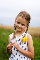 Young girl with flower at country