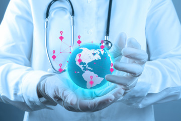 Medical Doctor holding a world globe in his hands as medical net