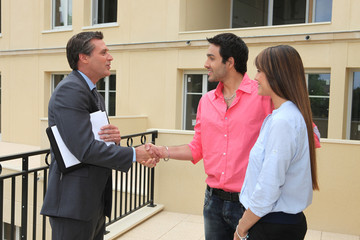 Estate agent shaking customers hand