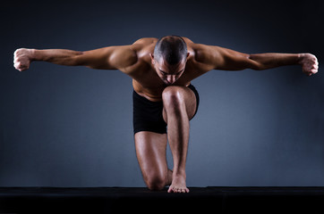Muscular man in dark studio