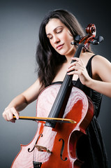 Woman cellist performing with cello © Elnur