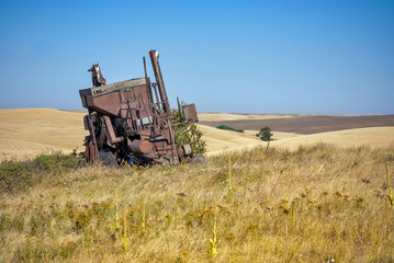 Antique Combine in a field on a farm