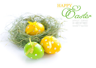 Colorful easter eggs and nest on a white background