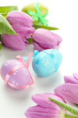 Bright easter eggs and tulips, isolated on white
