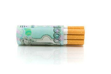 Cigarettes and money on a white background close-up