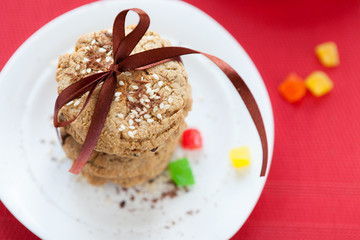 stack of oat cookies with sesame seeds on white plate