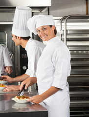 Female Chef Working In Restaurant Kitchen