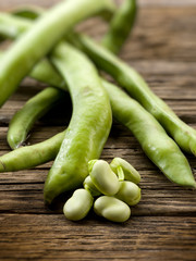 fresh beans broad over wood background, selective focus