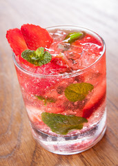 Strawberry mojito served with lime and crushed ice