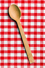 wooden spoon on checkered tablecloth