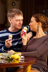 Girl and boy eating ice cream in the coffee