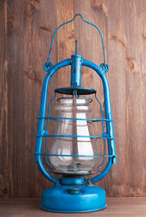 Old kerosene lantern on the dark wooden background