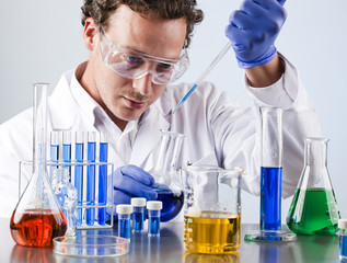 student in science analysing chemical solutions