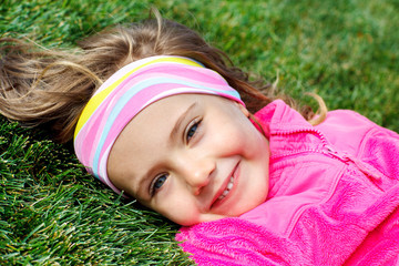 Preschool girl on green grass