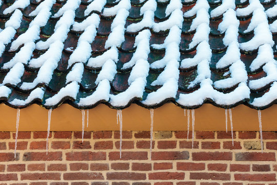 Icicles on the roof of an old Dutch farm