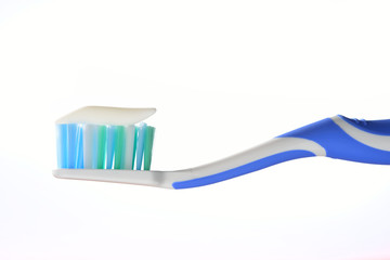 Toothbrush with tooth paste on white background