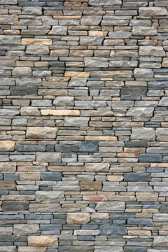 Ancient wall from slim granite brick.