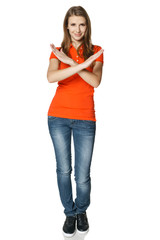 Smiling young woman in full length making stop gesture
