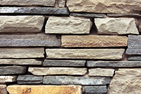 Close-up ancient wall from slim granite brick.