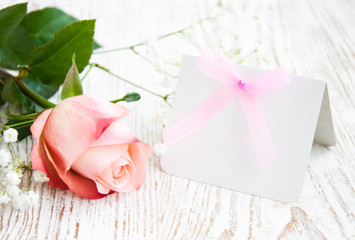 Blank card for your message and pink rose