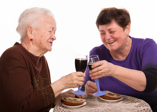 Happy mother with daughter drinking wine