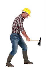 Tradesman using an axe to cut wood