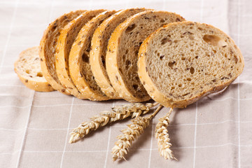 Healthy whole grain sliced bread with sunflower seeds on brown n