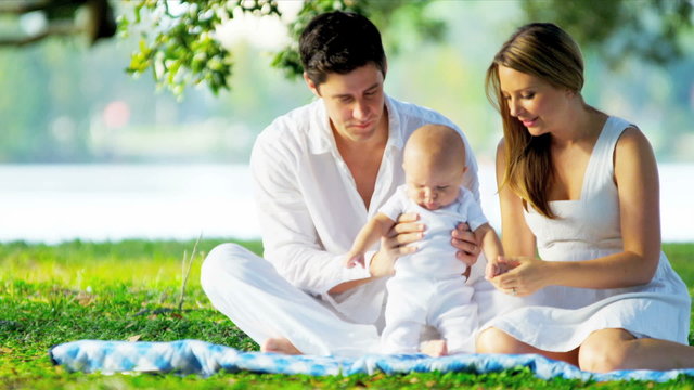 Young Caucasian Parents Baby Outdoors Park   