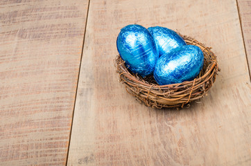 Small bird's nest with blue foil eggs