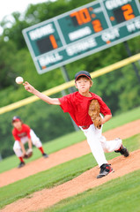 Young baseball player pitching the ball