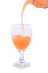 pouring a glass of orange juice creating splash