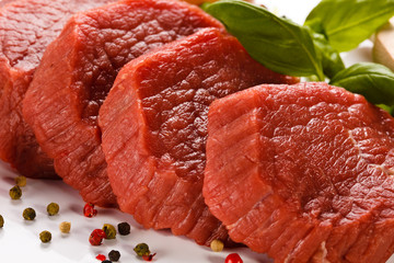 Raw beef and vegetables on white background