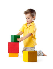 little boy plays with cubes, isolated on white