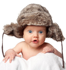 Sweet little baby in a huge fur hat